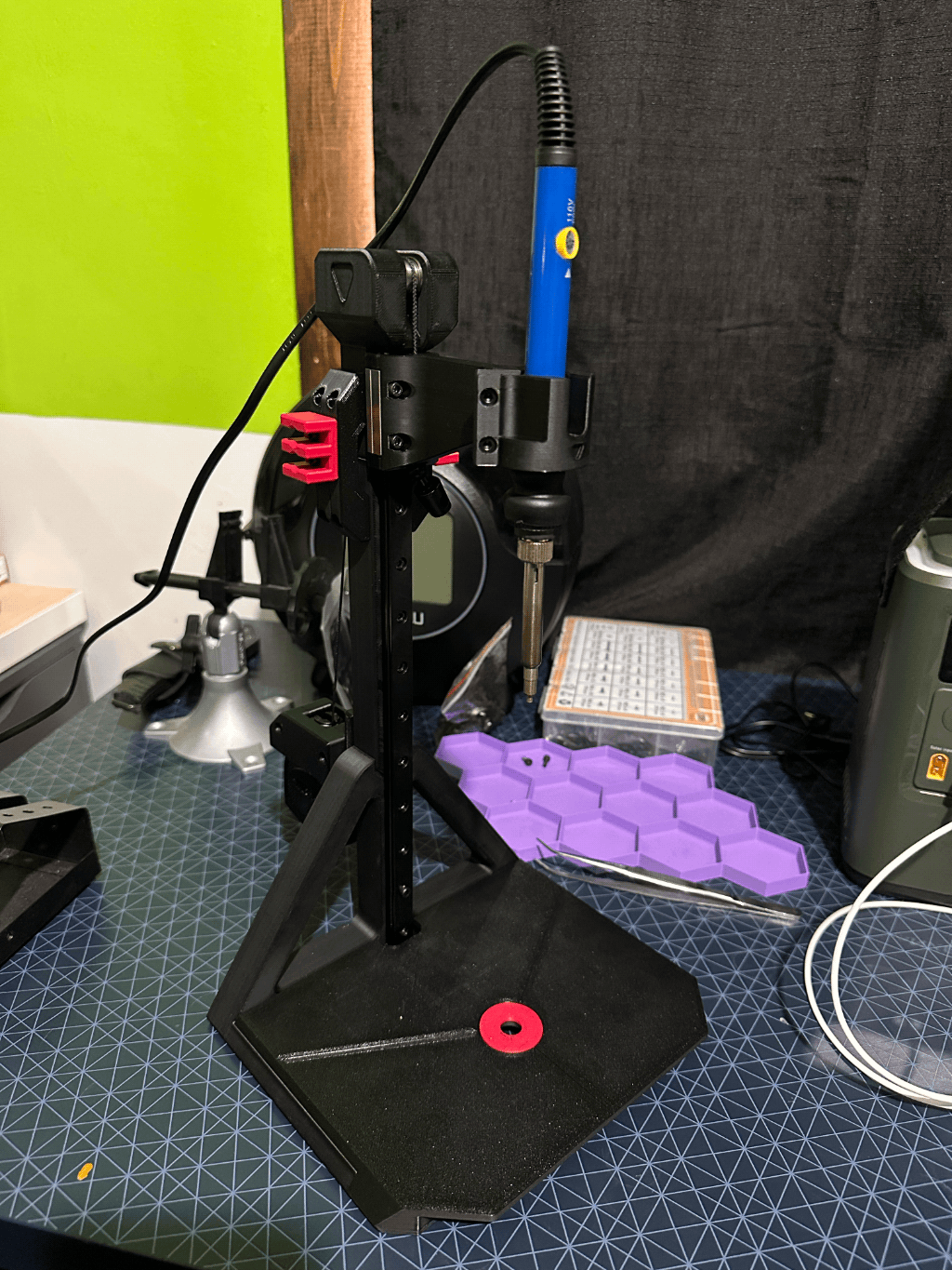 A 3D printed heat-set insert press holding a soldering iron vertically